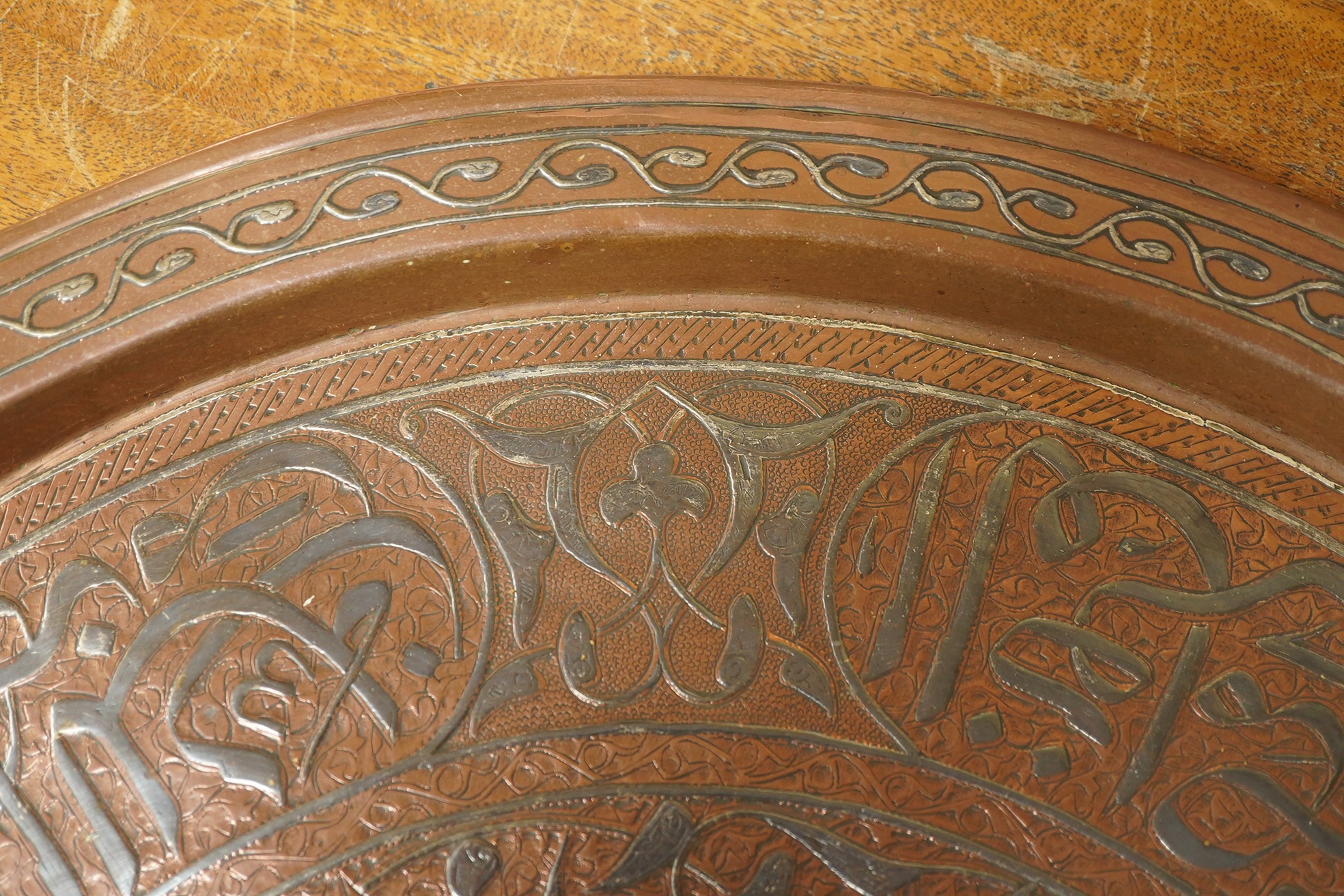 A Middle Eastern circular copper and niello damascened tray, 50cm in diameter. Condition - good